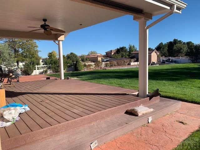 deck with ceiling fan and a lawn