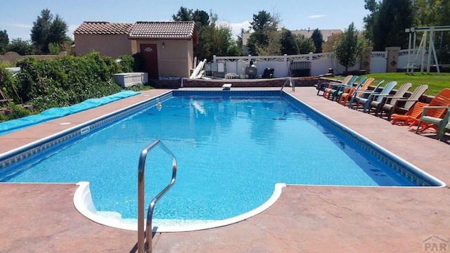 view of pool with a fenced backyard, a fenced in pool, and a patio