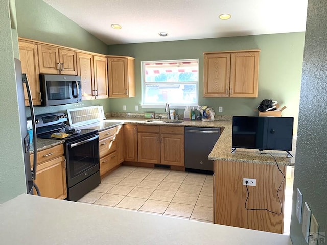 kitchen with appliances with stainless steel finishes, light countertops, a sink, and light tile patterned flooring