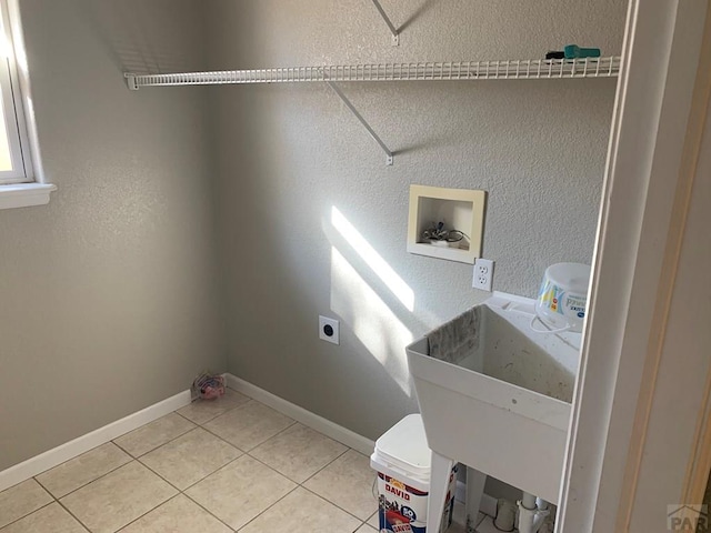 washroom featuring laundry area, tile patterned floors, hookup for a washing machine, hookup for an electric dryer, and a sink