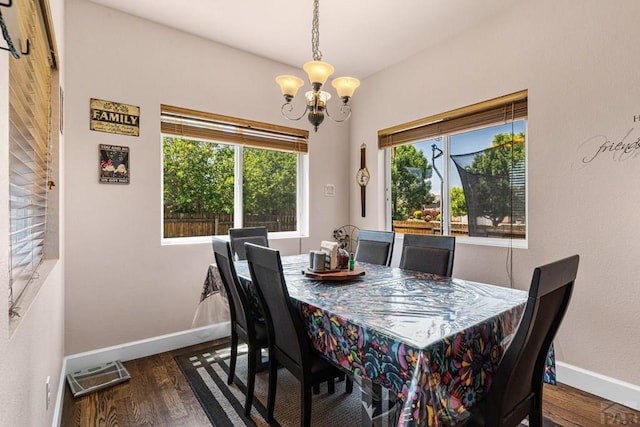 3327 Lions Pride Ln, Pueblo, CO 81005 - dining area with baseboards, a chandelier, and wood finished floors