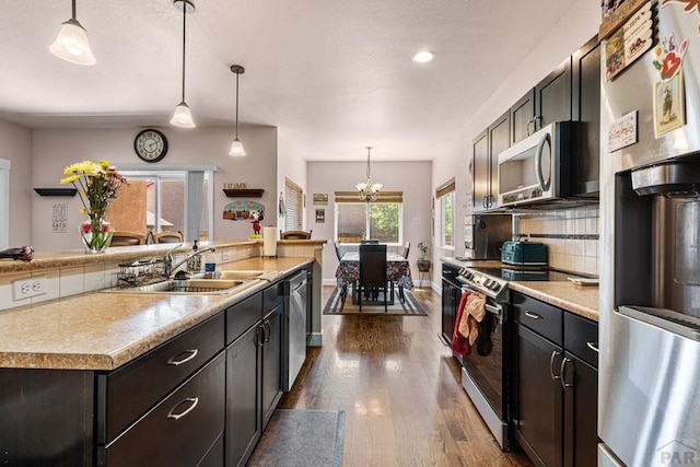 3327 Lions Pride Ln, Pueblo, CO 81005 - kitchen with appliances with stainless steel finishes, dark wood-style flooring, a sink, light countertops, and recessed lighting