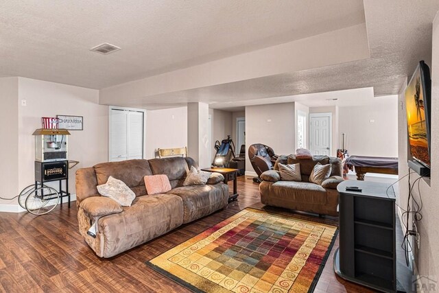 3327 Lions Pride Ln, Pueblo, CO 81005 - living room featuring wood finished floors, a textured ceiling, and baseboards