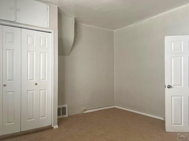 interior space with carpet, visible vents, and baseboards