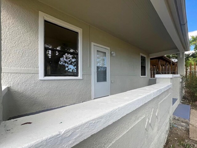 view of exterior entry featuring stucco siding