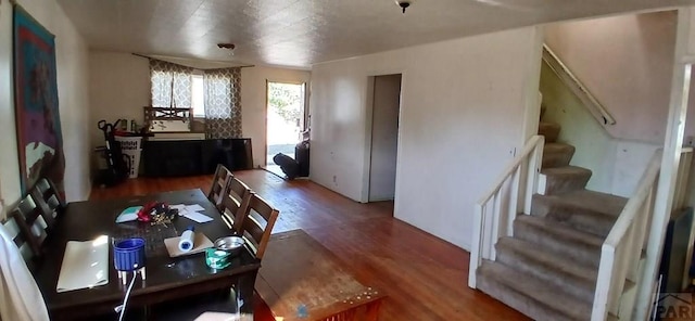 living area featuring stairway and wood finished floors