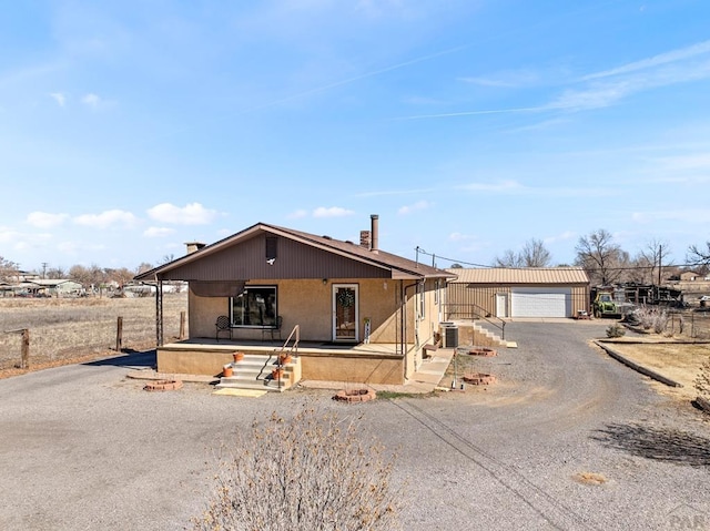 view of front of house featuring an outbuilding and a detached garage