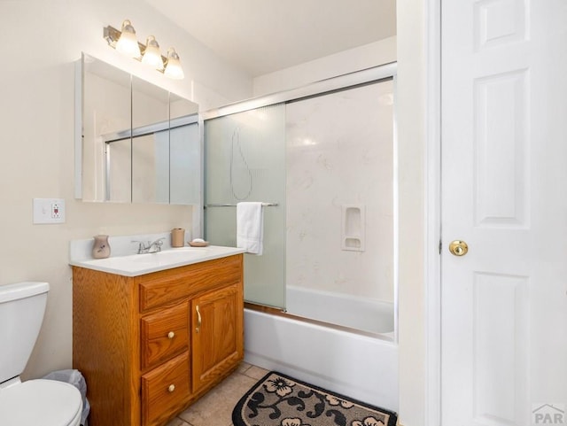 1040 28th Ln, Pueblo, CO 81006 - full bath featuring toilet, tile patterned flooring, combined bath / shower with glass door, and vanity