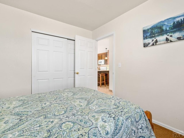 1040 28th Ln, Pueblo, CO 81006 - carpeted bedroom featuring a closet and baseboards