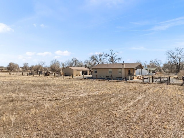 1040 28th Ln, Pueblo, CO 81006 - rear view of property featuring a rural view and fence