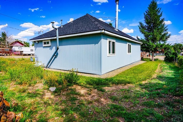 202 Pinon St, Walsenburg, CO 81089 - view of side of home featuring a lawn and a shingled roof