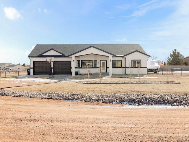 modern farmhouse style home with a garage, fence, and concrete driveway