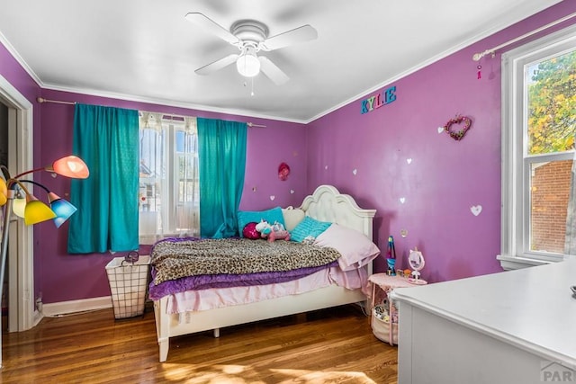 bedroom with ornamental molding, a ceiling fan, baseboards, and wood finished floors