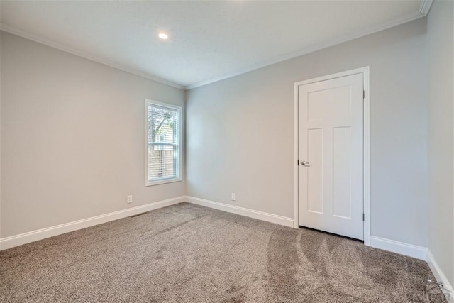 unfurnished room featuring carpet floors, baseboards, and ornamental molding