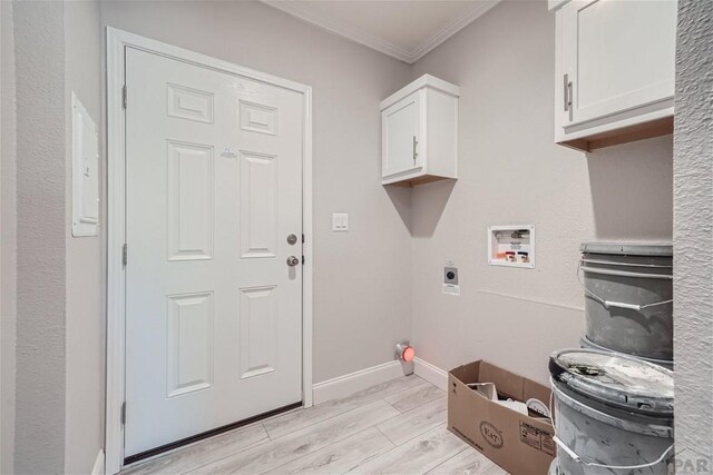 laundry room featuring washer hookup, crown molding, cabinet space, electric dryer hookup, and baseboards