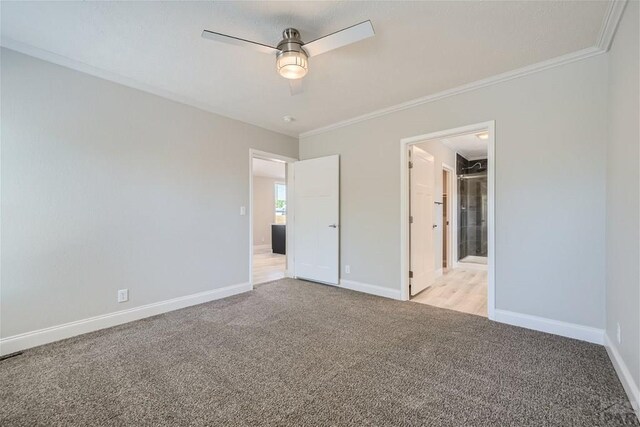 unfurnished bedroom featuring ornamental molding, light carpet, and baseboards