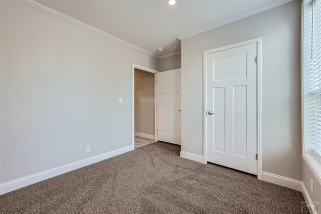 unfurnished bedroom featuring baseboards, ornamental molding, carpet flooring, and recessed lighting