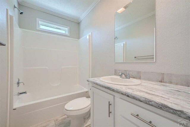 full bath featuring toilet, ornamental molding, bathing tub / shower combination, and vanity