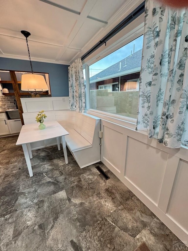 303 S Animas St, Trinidad, CO 81082 - dining area featuring wainscoting and a decorative wall