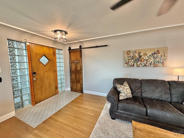 303 S Animas St, Trinidad, CO 81082 - foyer entrance featuring a textured ceiling, a barn door, and wood finished floors