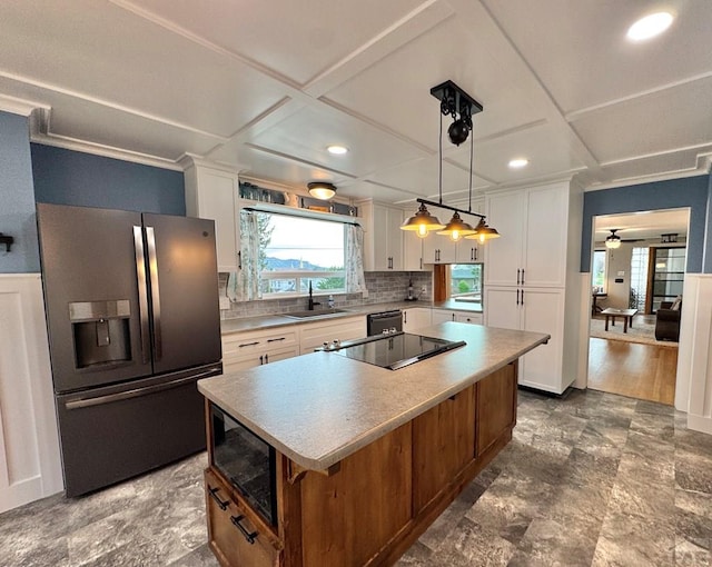 303 S Animas St, Trinidad, CO 81082 - kitchen featuring black appliances, coffered ceiling, white cabinetry, a kitchen island, and tasteful backsplash