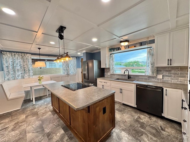 303 S Animas St, Trinidad, CO 81082 - kitchen featuring dishwasher, stainless steel refrigerator with ice dispenser, black electric stovetop, a kitchen island, and white cabinets