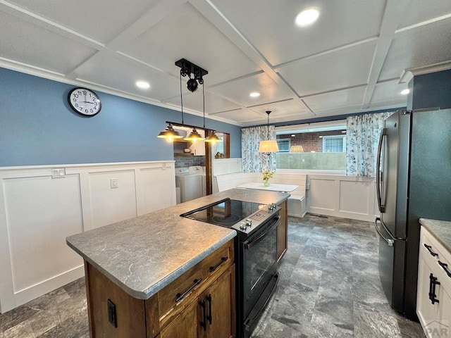 303 S Animas St, Trinidad, CO 81082 - kitchen featuring black range with electric stovetop, freestanding refrigerator, coffered ceiling, a kitchen island, and a decorative wall