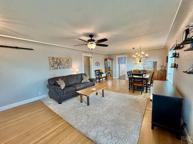 303 S Animas St, Trinidad, CO 81082 - living room featuring light wood finished floors, ceiling fan, and a chandelier