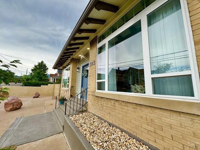 303 S Animas St, Trinidad, CO 81082 - view of property exterior with entry steps, brick siding, and a patio area