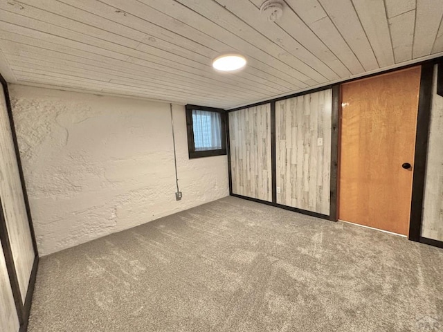 303 S Animas St, Trinidad, CO 81082 - basement featuring a textured wall, carpet flooring, and wooden ceiling