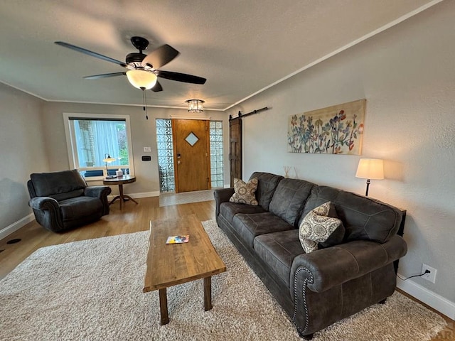 303 S Animas St, Trinidad, CO 81082 - living area with a barn door, a ceiling fan, wood finished floors, and a textured ceiling