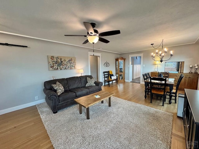 303 S Animas St, Trinidad, CO 81082 - living area with light wood-type flooring, a chandelier, and a ceiling fan