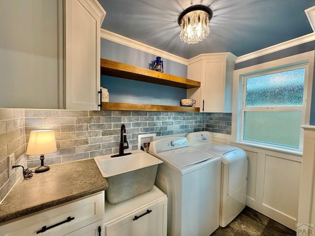 303 S Animas St, Trinidad, CO 81082 - laundry room with washing machine and dryer, cabinet space, ornamental molding, and a chandelier