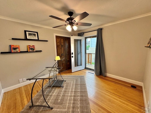 303 S Animas St, Trinidad, CO 81082 - foyer entrance featuring a ceiling fan, ornamental molding, wood finished floors, and a textured ceiling