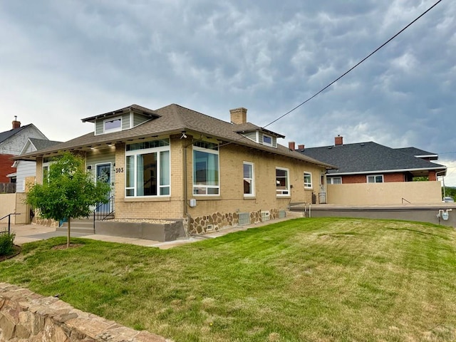 303 S Animas St, Trinidad, CO 81082 - rear view of house with brick siding, a chimney, and a shingled roof