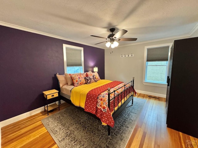 303 S Animas St, Trinidad, CO 81082 - bedroom featuring hardwood / wood-style floors, crown molding, ceiling fan, and a textured ceiling