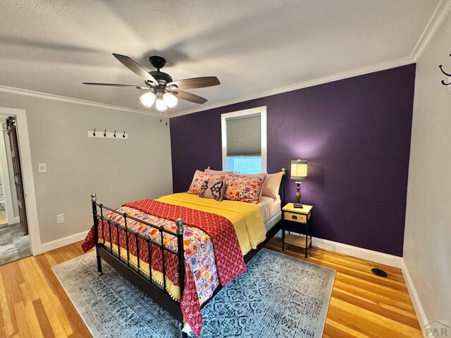 303 S Animas St, Trinidad, CO 81082 - bedroom featuring wood finished floors, crown molding, and ceiling fan