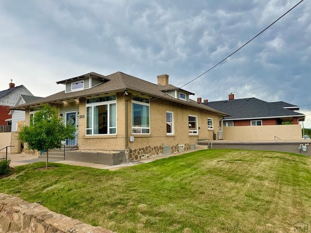 303 S Animas St, Trinidad, CO 81082 - rear view of property featuring brick siding and a chimney