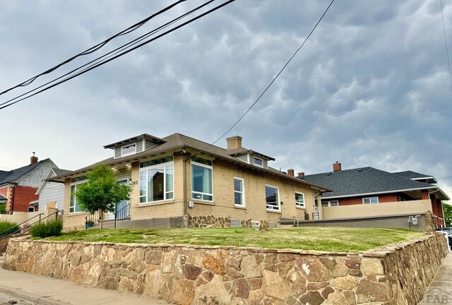 303 S Animas St, Trinidad, CO 81082 - view of side of property featuring brick siding and a chimney
