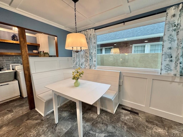 303 S Animas St, Trinidad, CO 81082 - dining space with wainscoting, a decorative wall, ornamental molding, washer / clothes dryer, and plenty of natural light