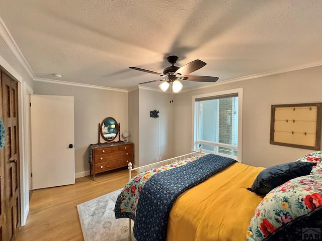 303 S Animas St, Trinidad, CO 81082 - bedroom with light wood finished floors, a textured ceiling, ornamental molding, and ceiling fan