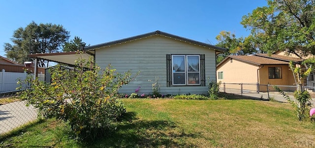 view of property exterior with an attached carport, a fenced backyard, and a yard