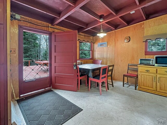 1005 County Road 132, Westcliffe, CO 81252 - dining area with wood walls, coffered ceiling, plenty of natural light, and beamed ceiling