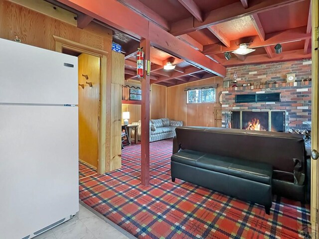 1005 County Road 132, Westcliffe, CO 81252 - living area featuring wood walls, beam ceiling, and a fireplace