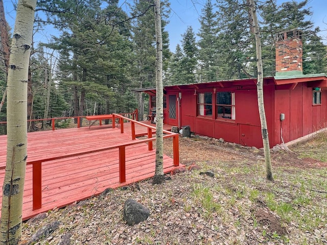 1005 County Road 132, Westcliffe, CO 81252 - view of side of home featuring a chimney and a wooden deck