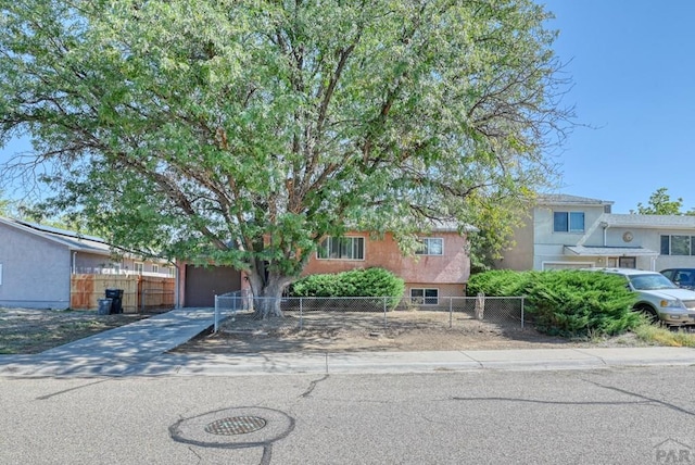 view of front of home featuring driveway and fence