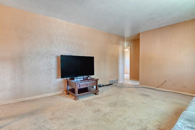 carpeted living room with visible vents and baseboards