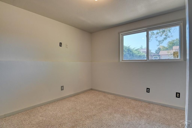 empty room with light carpet and baseboards