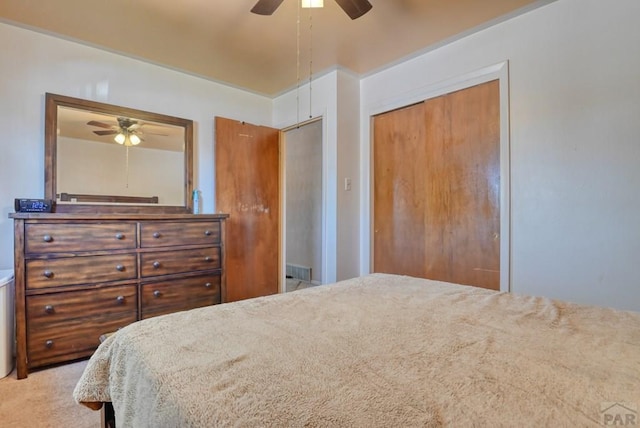 carpeted bedroom featuring a closet and ceiling fan