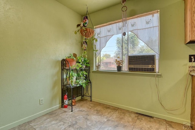 unfurnished dining area featuring cooling unit, visible vents, and baseboards